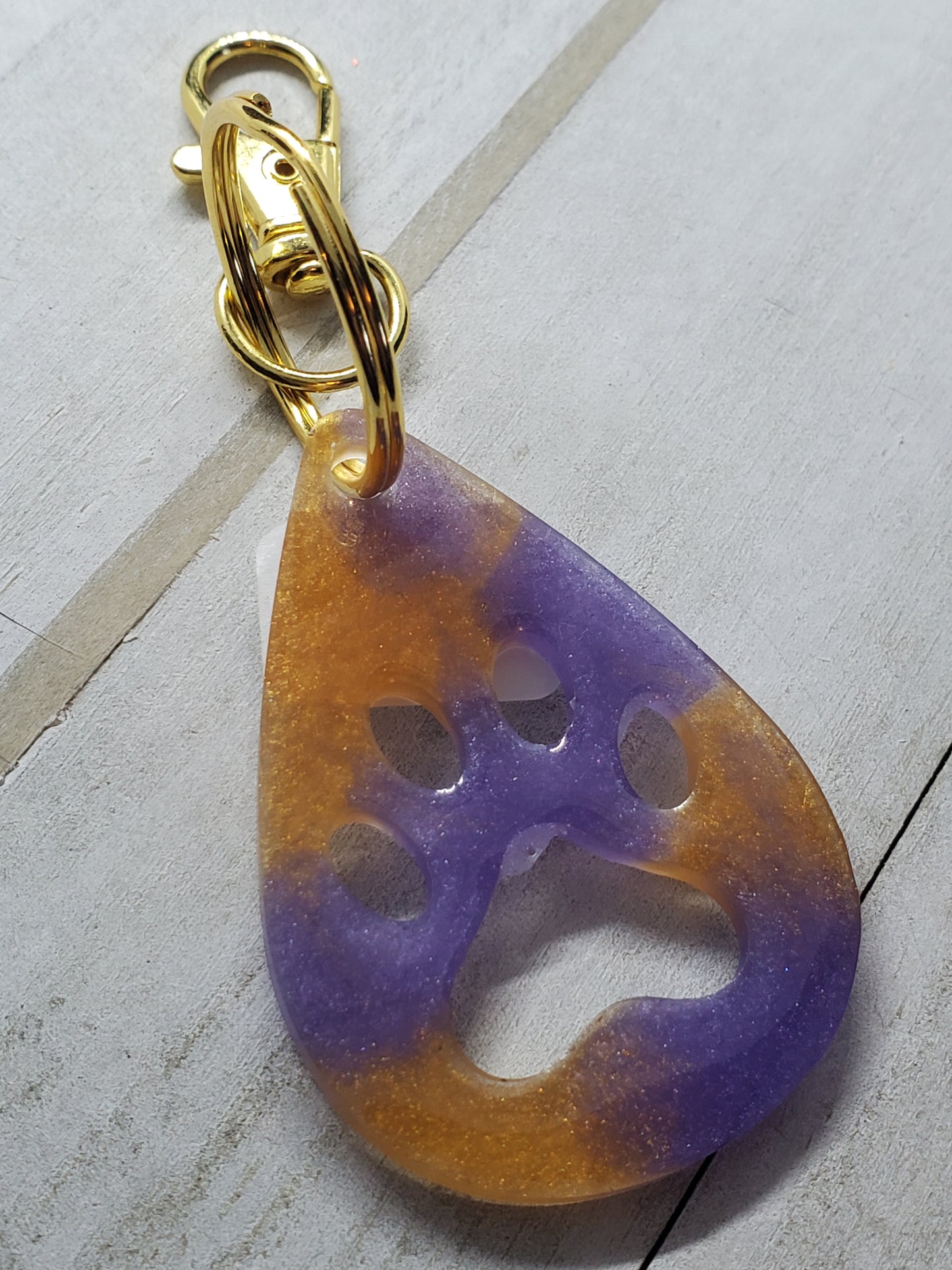 Purple and gold paw print keychain