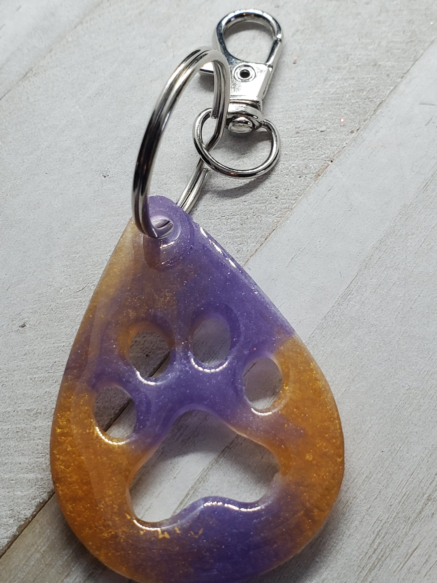 Purple and gold paw print keychain