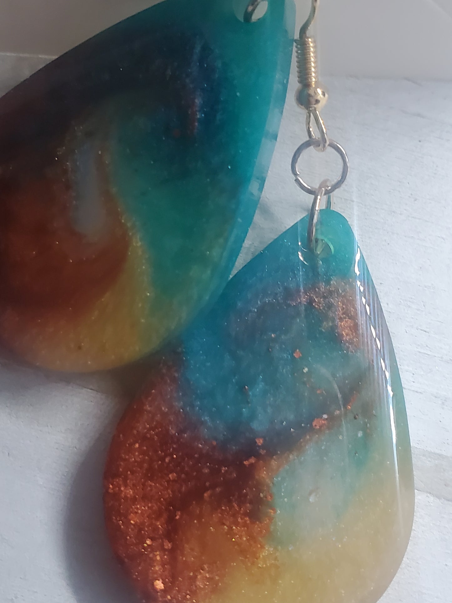 amber, gold, and teal earrings in gold