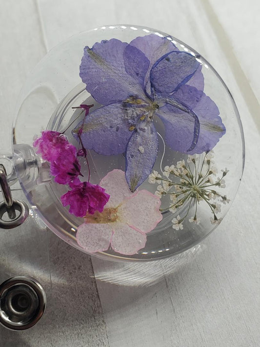 purple and pink flower badge reel